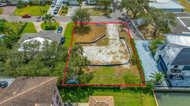 an aerial view of a house with a yard and lake view