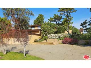 12251 Castlegate Drive Los Angeles, CA 90049 - Photo 2 of 38 a black and white photo of a house