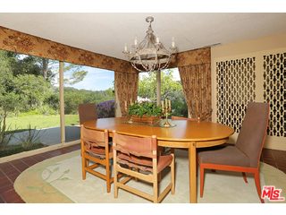 12251 Castlegate Drive Los Angeles, CA 90049 - Photo 12 of 38 a dining room with furniture and a floor to ceiling window