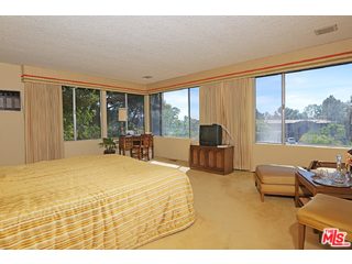 12251 Castlegate Drive Los Angeles, CA 90049 - Photo 19 of 38 a bedroom with furniture and large windows