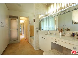 12251 Castlegate Drive Los Angeles, CA 90049 - Photo 20 of 38 a bathroom with a sink and mirror