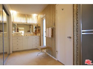 12251 Castlegate Drive Los Angeles, CA 90049 - Photo 21 of 38 a view of a bathroom with a shower and a sink
