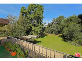 12251 Castlegate Drive Los Angeles, CA 90049 - Photo 23 of 38 a view of a pathway both side of building with yard