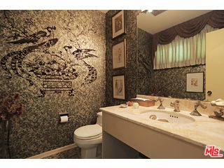 12251 Castlegate Drive Los Angeles, CA 90049 - Photo 24 of 38 a bathroom with a sink toilet and a mirror