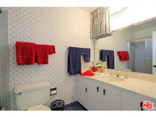 12251 Castlegate Drive Los Angeles, CA 90049 - Photo 26 of 38 a bathroom with a sink and a mirror