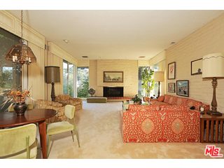 12251 Castlegate Drive Los Angeles, CA 90049 - Photo 6 of 38 a living room with furniture a flat screen tv and a fireplace