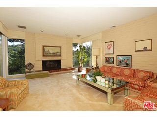 12251 Castlegate Drive Los Angeles, CA 90049 - Photo 8 of 38 a living room with furniture and a fireplace
