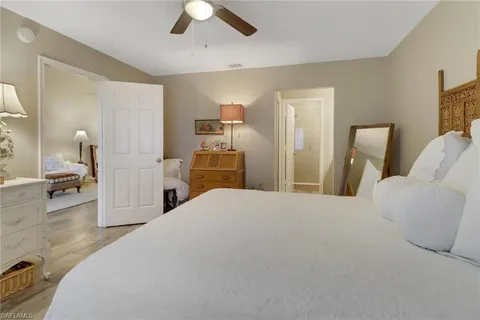 a bedroom with a bed and a large mirror