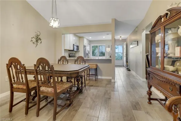 a view of a dining room with furniture and wooden floor