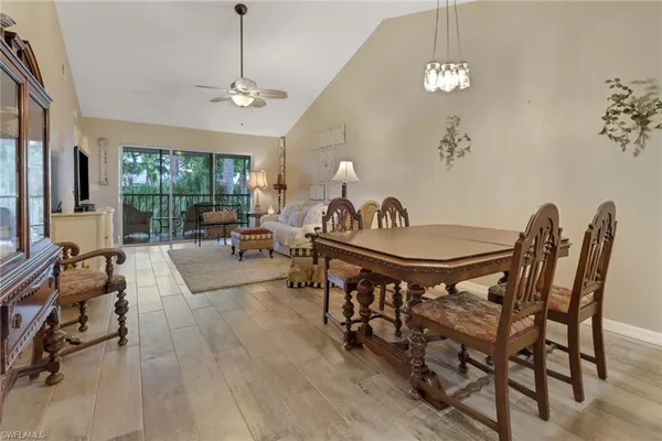 a living room with furniture a chandelier and a window