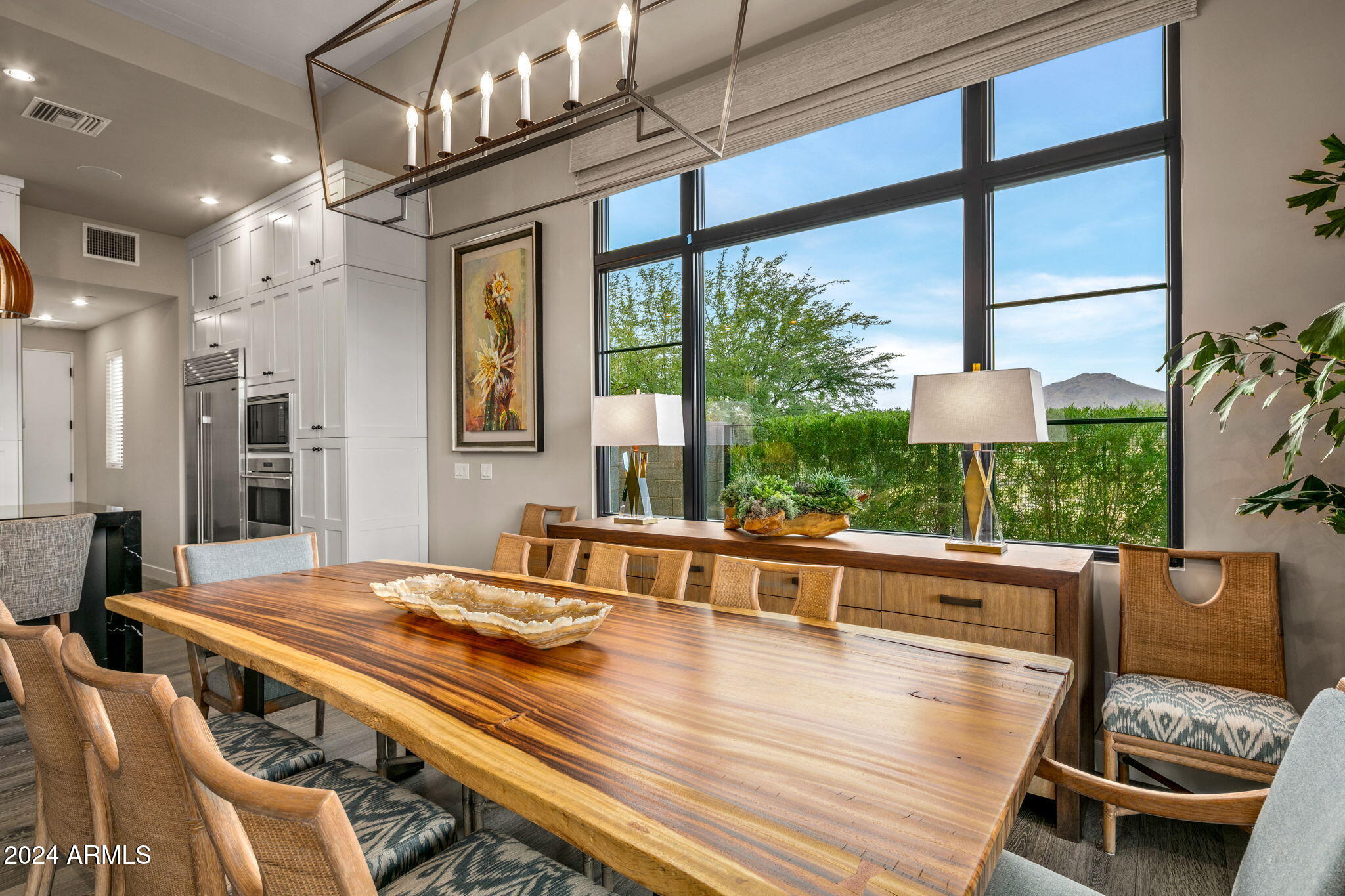 37200 North Cave Creek Road, Unit 1082 Scottsdale, AZ 85262 - Photo 26 of 66 a view of a dining room with furniture a chandelier and wooden floor