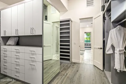 a large white kitchen with a large window and sink