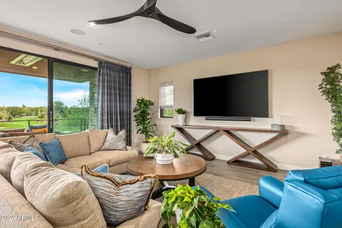 a outdoor living space with furniture and a flat screen tv