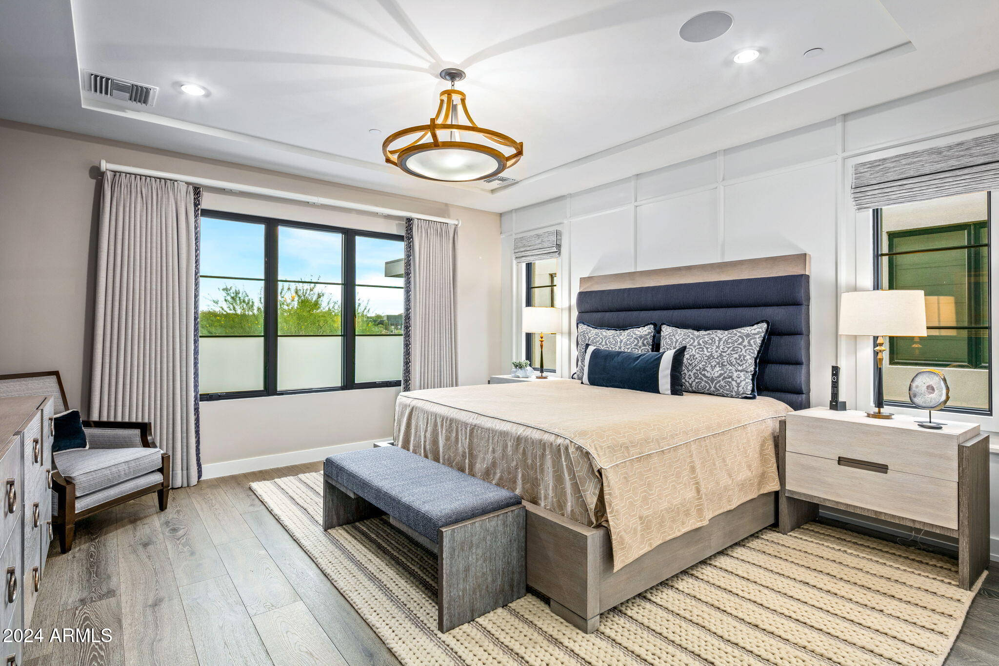 37200 North Cave Creek Road, Unit 1082 Scottsdale, AZ 85262 - Photo 48 of 66 a bedroom with a large bed and a chandelier