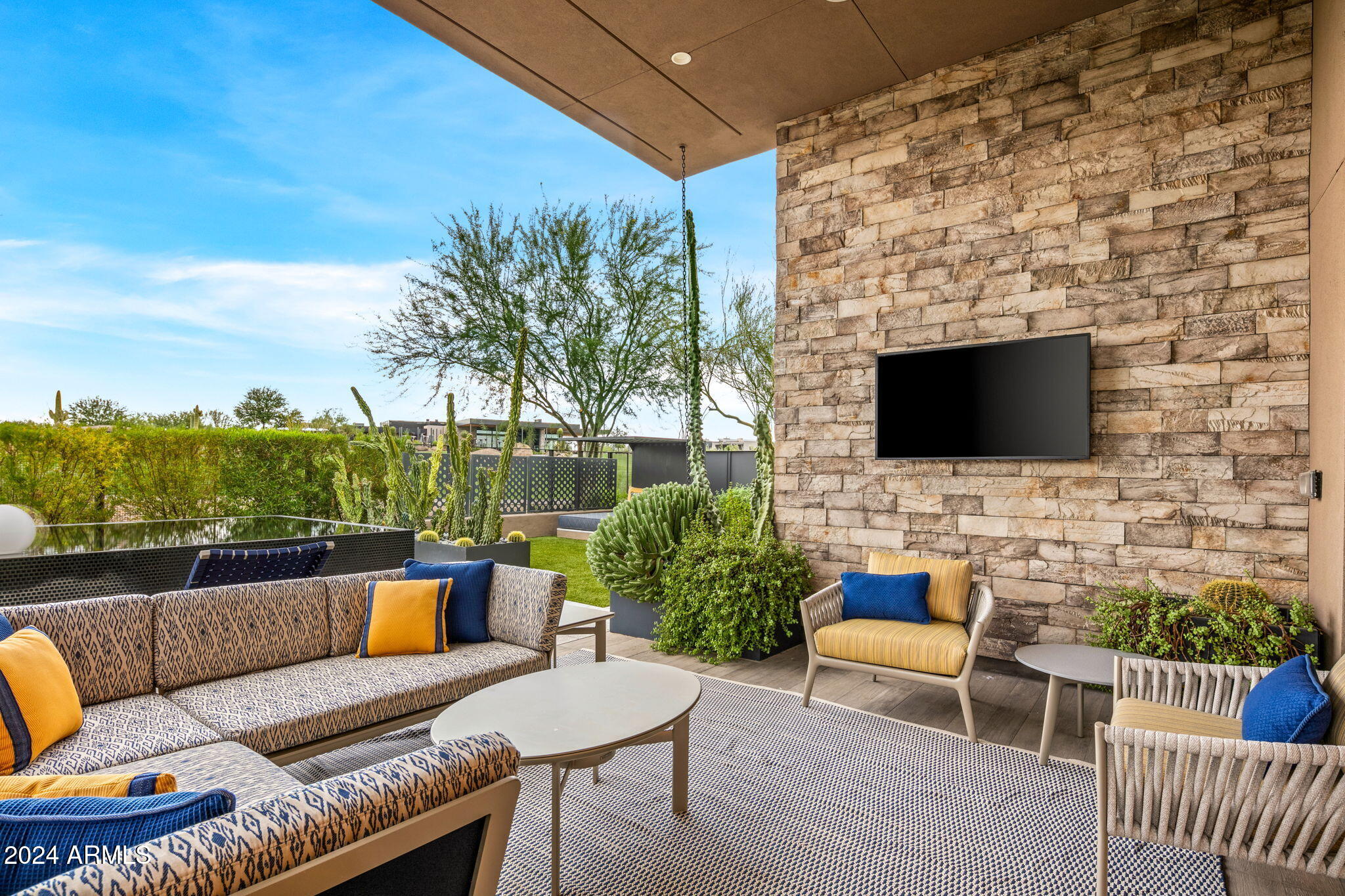 37200 North Cave Creek Road, Unit 1082 Scottsdale, AZ 85262 - Photo 58 of 66 a outdoor living space with furniture and a flat screen tv