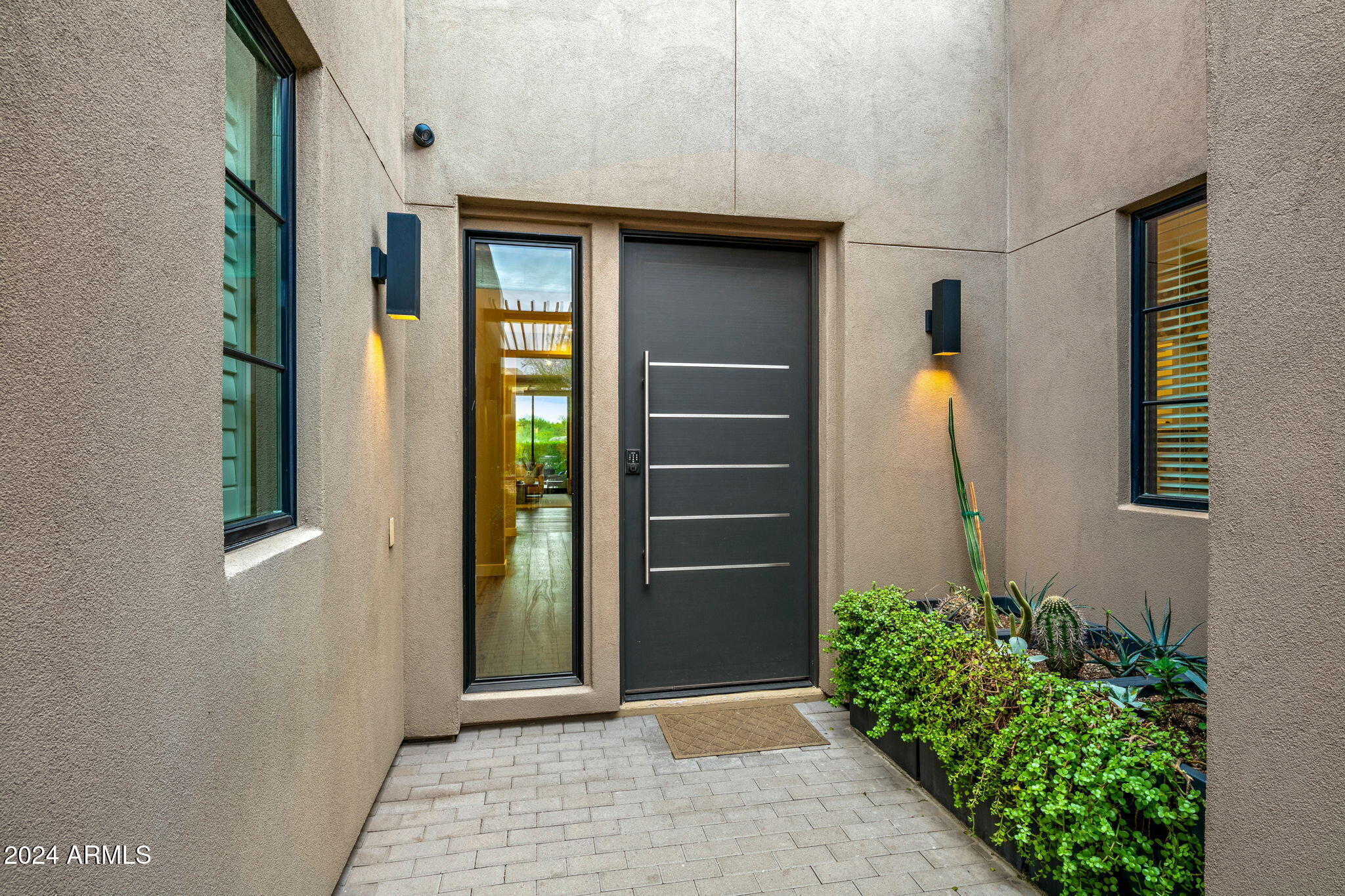 37200 North Cave Creek Road, Unit 1082 Scottsdale, AZ 85262 - Photo 9 of 66 a front view of a house with a potted plant and garage