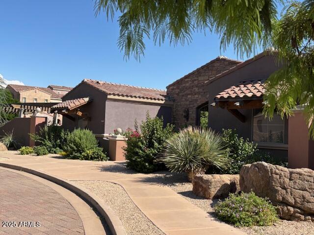 3935 East Rough Rider Road, Unit 1014 Phoenix, AZ 85050 - Photo 24 of 40 a view of a house with a street