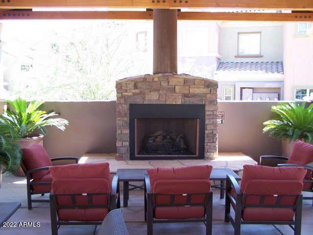 3935 East Rough Rider Road, Unit 1014 Phoenix, AZ 85050 - Photo 35 of 40 a living room with furniture a window and a fireplace