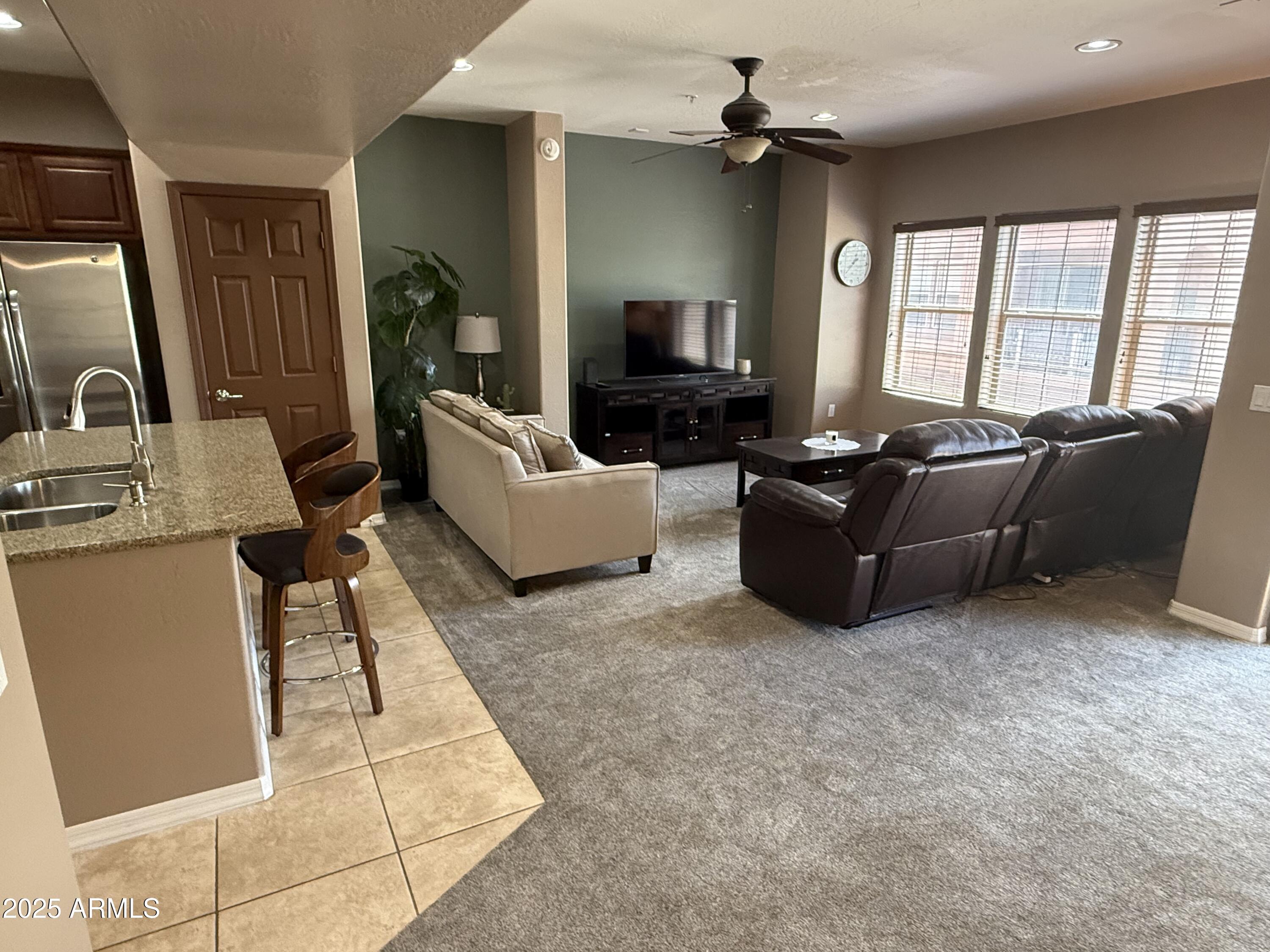 3935 East Rough Rider Road, Unit 1014 Phoenix, AZ 85050 - Photo 8 of 40 a living room with furniture