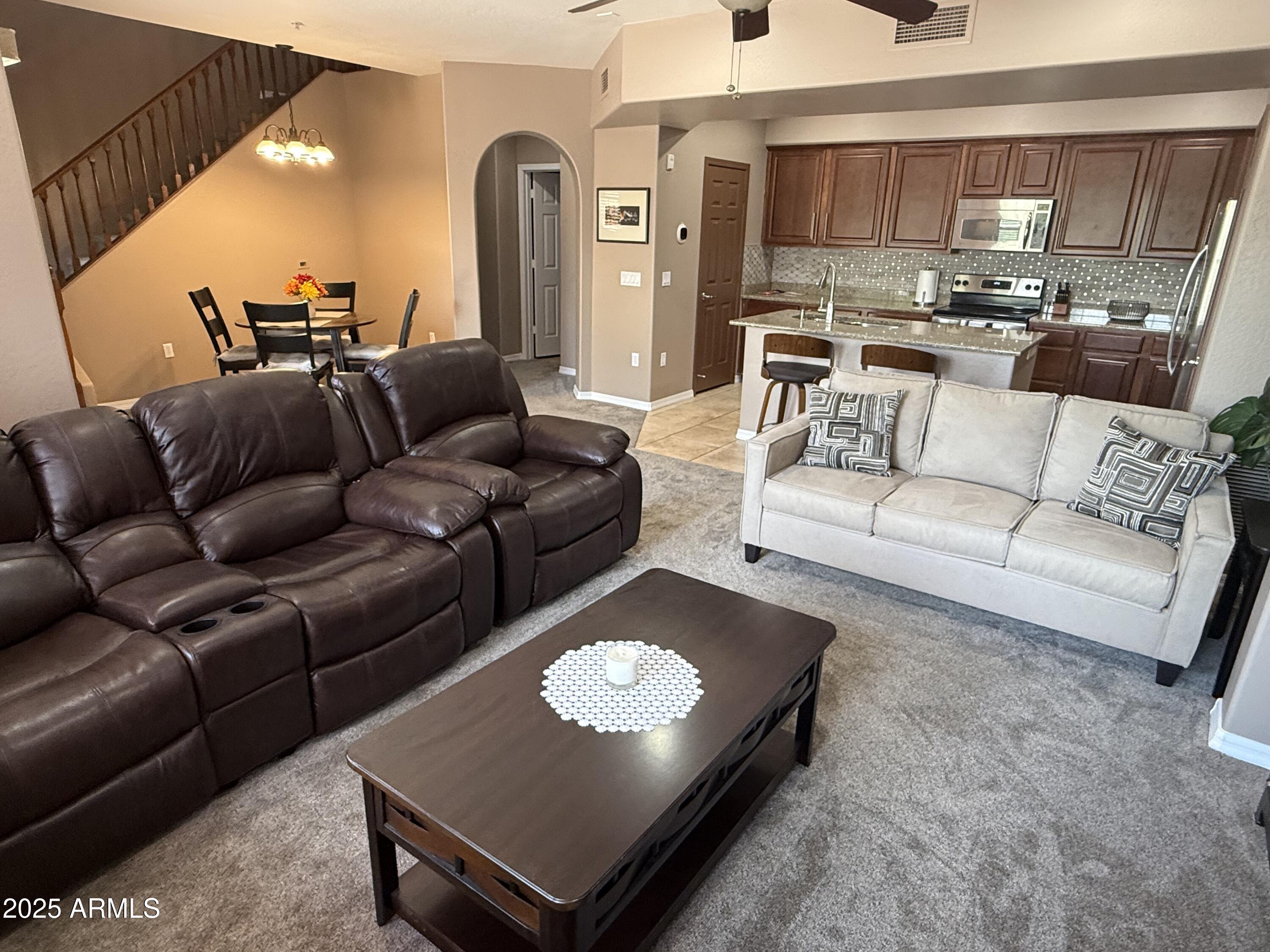 3935 East Rough Rider Road, Unit 1014 Phoenix, AZ 85050 - Photo 9 of 40 a living room with furniture and a table