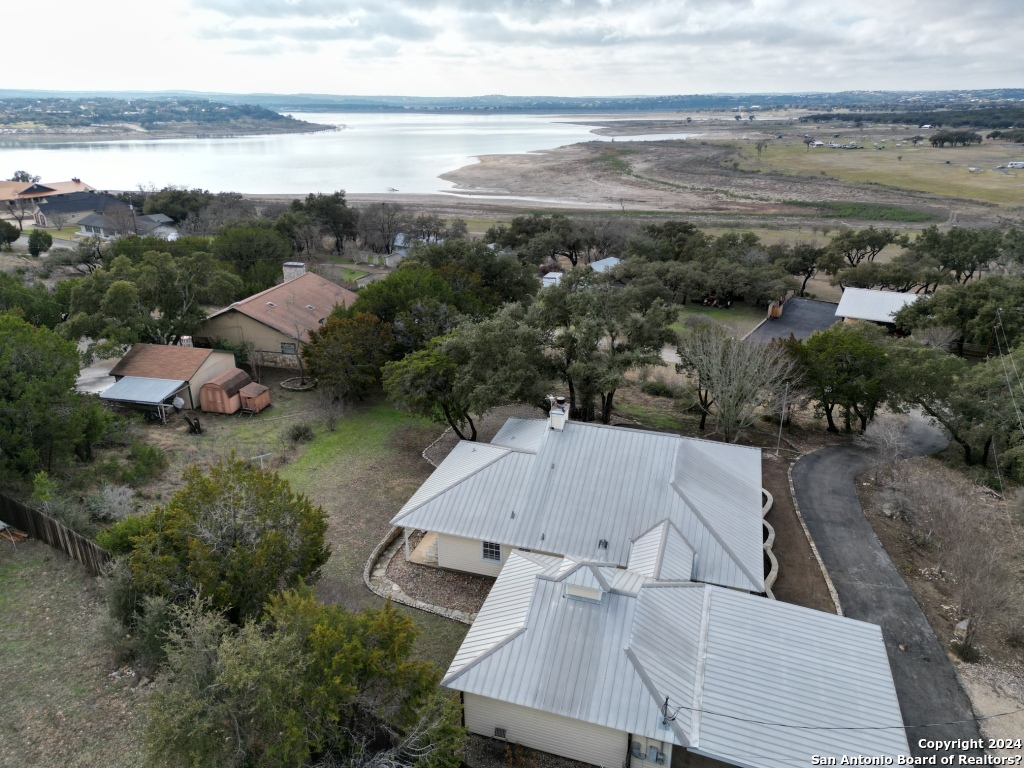 an aerial view of residential houses with outdoor space and ocean