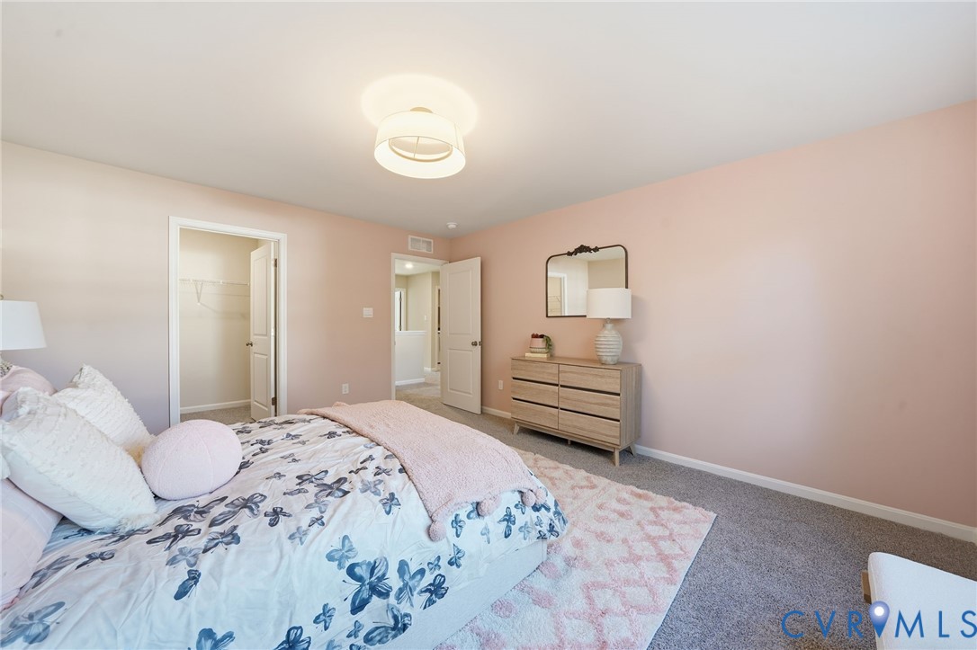 6338 Sterling Way Ruther Glen, VA 22546 - Photo 32 of 47 a bedroom with a bed and dresser