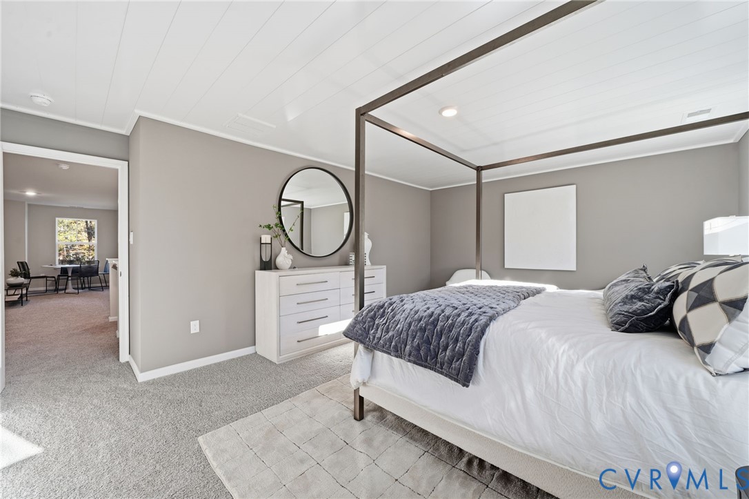 6338 Sterling Way Ruther Glen, VA 22546 - Photo 34 of 47 a bedroom with a large bed and a chandelier