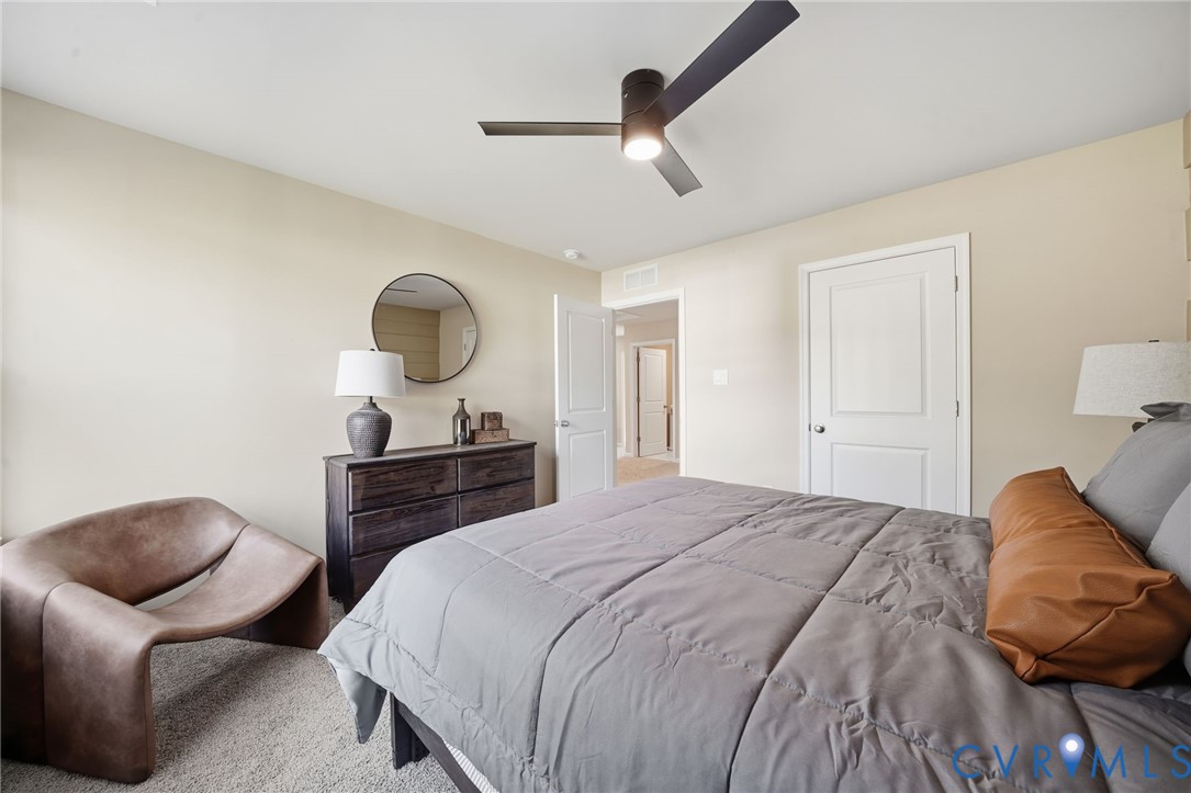 6338 Sterling Way Ruther Glen, VA 22546 - Photo 39 of 47 a bedroom with a bed and a chair