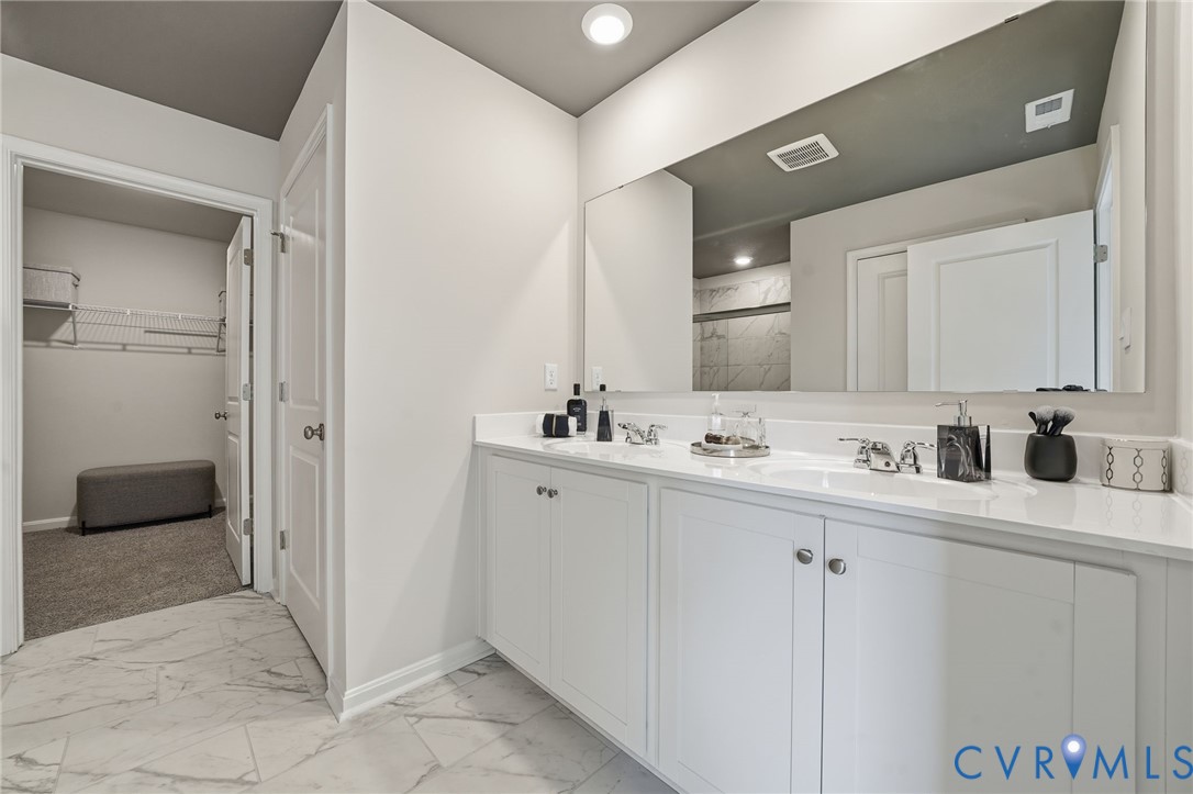 6338 Sterling Way Ruther Glen, VA 22546 - Photo 42 of 47 a bathroom with a double vanity sink a mirror and a