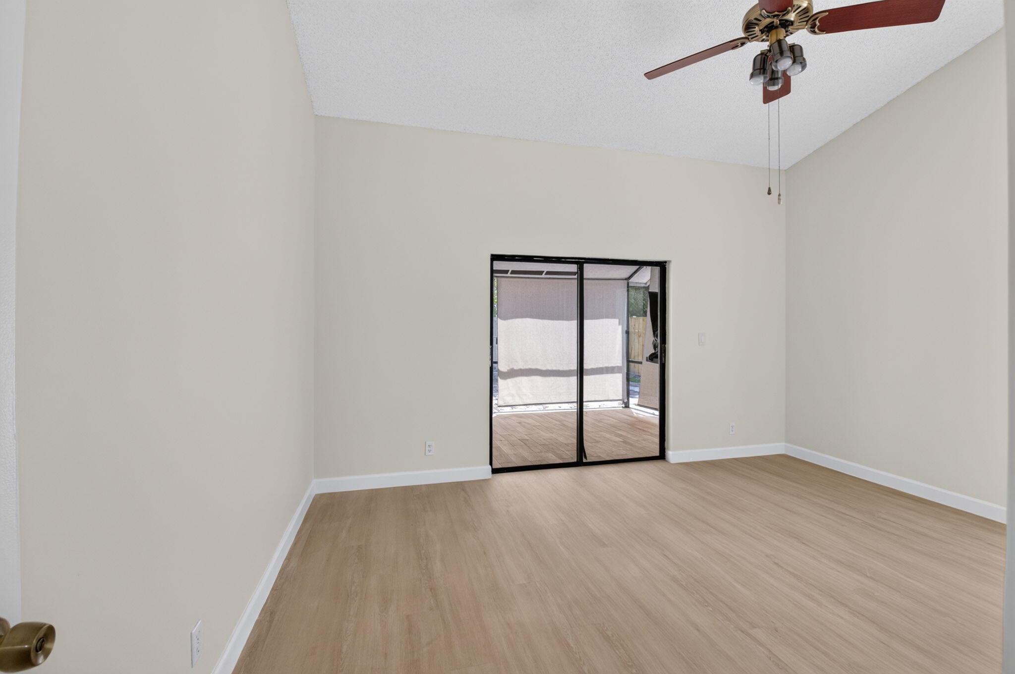 21070 Woodspring Avenue Boca Raton, FL 33428 - Photo 14 of 30 a view of an empty room with a window and wooden floor