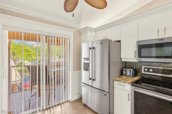 a kitchen with a refrigerator and a stove top oven