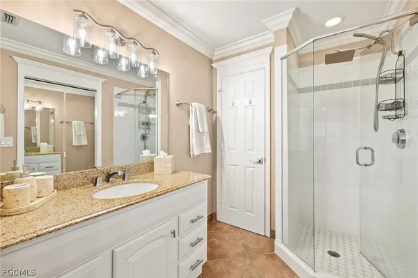 a bathroom with a granite countertop shower sink and mirror