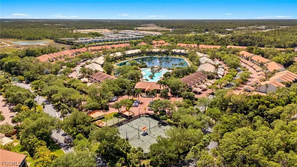 a view of a swimming pool with a patio and a yard