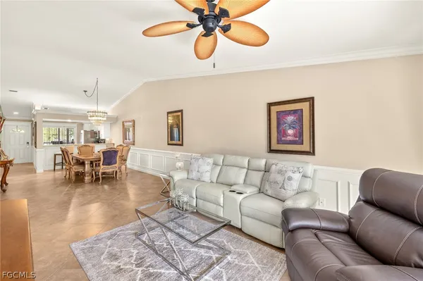 a living room with furniture and kitchen view