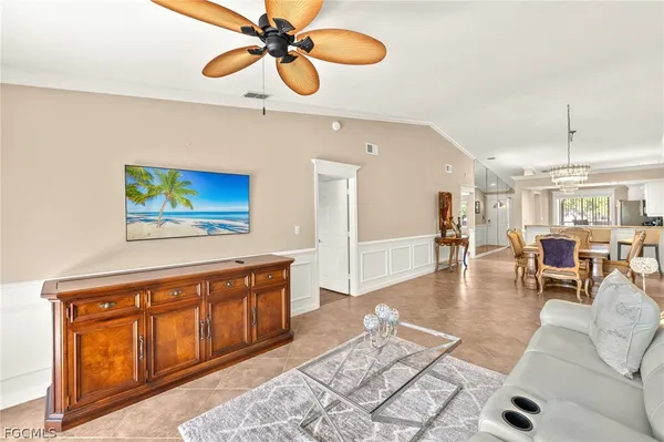 a living room with furniture and a chandelier