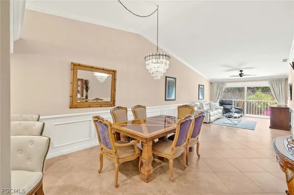a view of a dining room with furniture and a chandelier