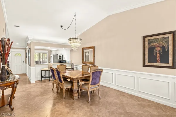 a view of a dining room with furniture and chandelier