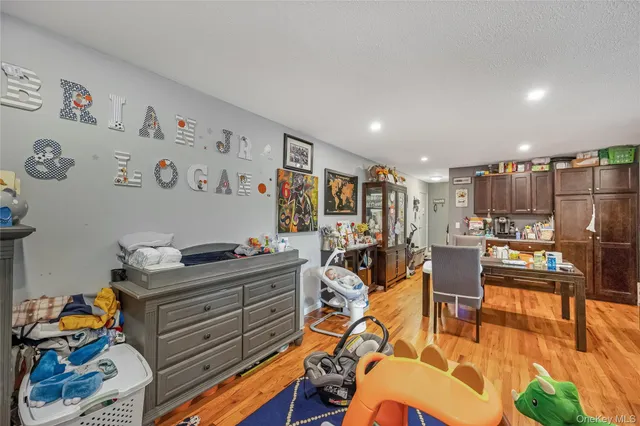 a view of a dining room with furniture a rug and wooden floor