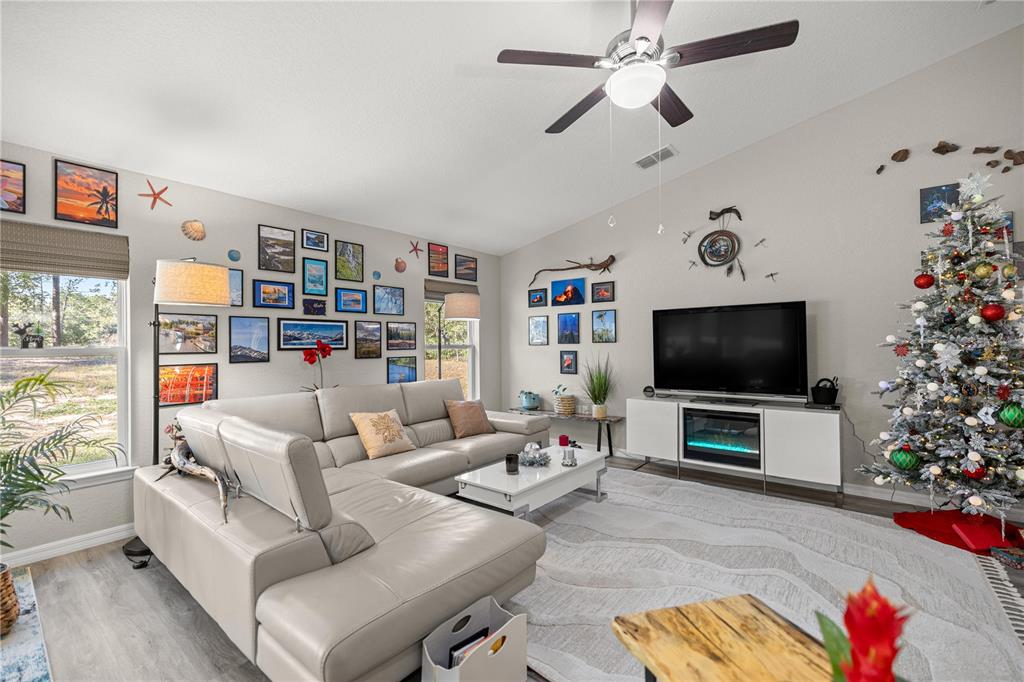 9239 Southwest 197th Circle Dunnellon, FL 34432 - Photo 17 of 57 a living room with furniture and a flat screen tv