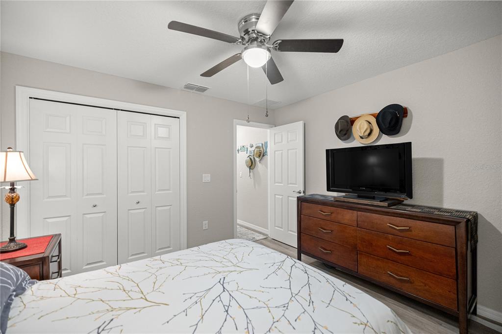 9239 Southwest 197th Circle Dunnellon, FL 34432 - Photo 21 of 57 a bedroom with a bed and a flat screen tv