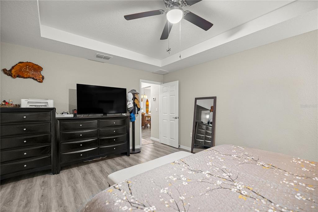 9239 Southwest 197th Circle Dunnellon, FL 34432 - Photo 23 of 57 a bedroom with a bed and a flat screen tv