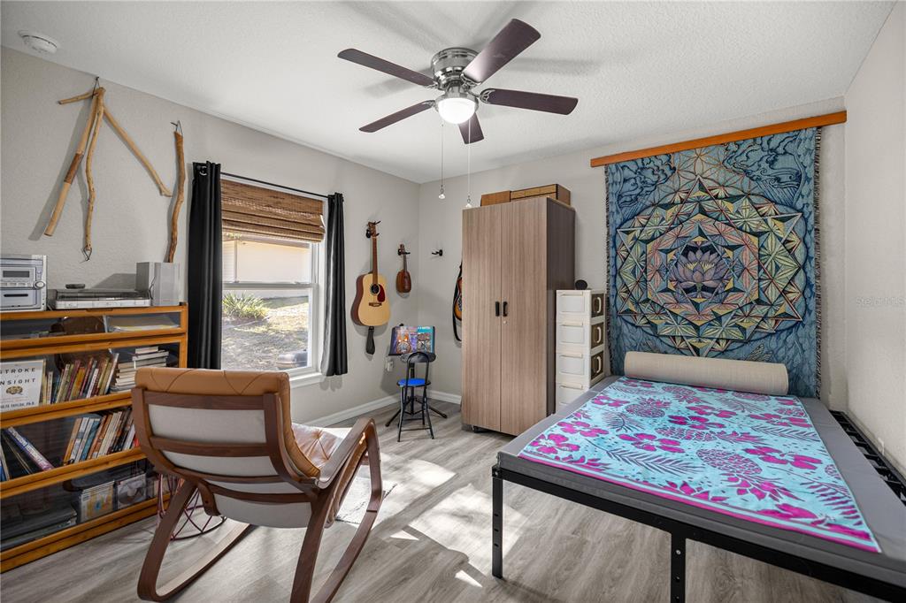 9239 Southwest 197th Circle Dunnellon, FL 34432 - Photo 27 of 57 a living room with a couch and a bookshelf