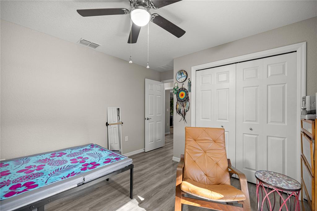 9239 Southwest 197th Circle Dunnellon, FL 34432 - Photo 28 of 57 a bedroom with furniture and a chandelier fan