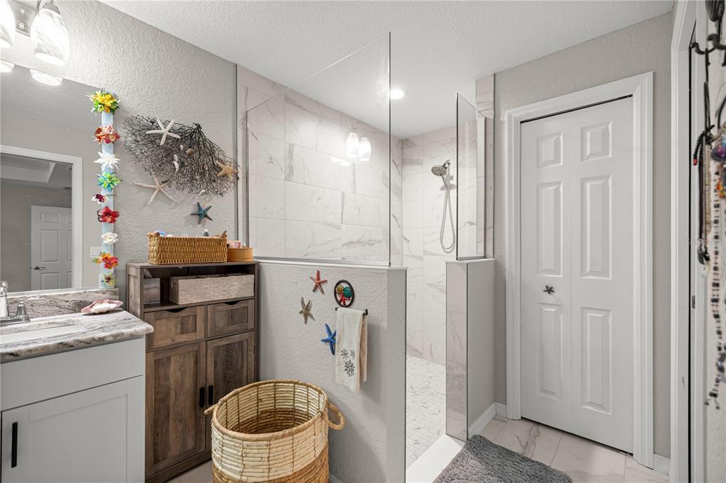 9239 Southwest 197th Circle Dunnellon, FL 34432 - Photo 30 of 57 a bathroom with a sink a toilet and shower curtain