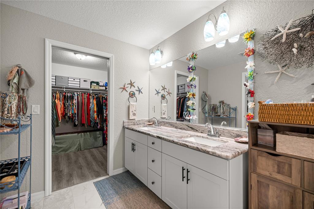 9239 Southwest 197th Circle Dunnellon, FL 34432 - Photo 31 of 57 a bathroom with a sink double vanity granite and a shower
