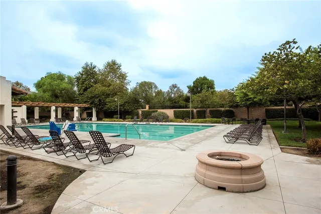 a view of backyard with swimming pool and outdoor seating