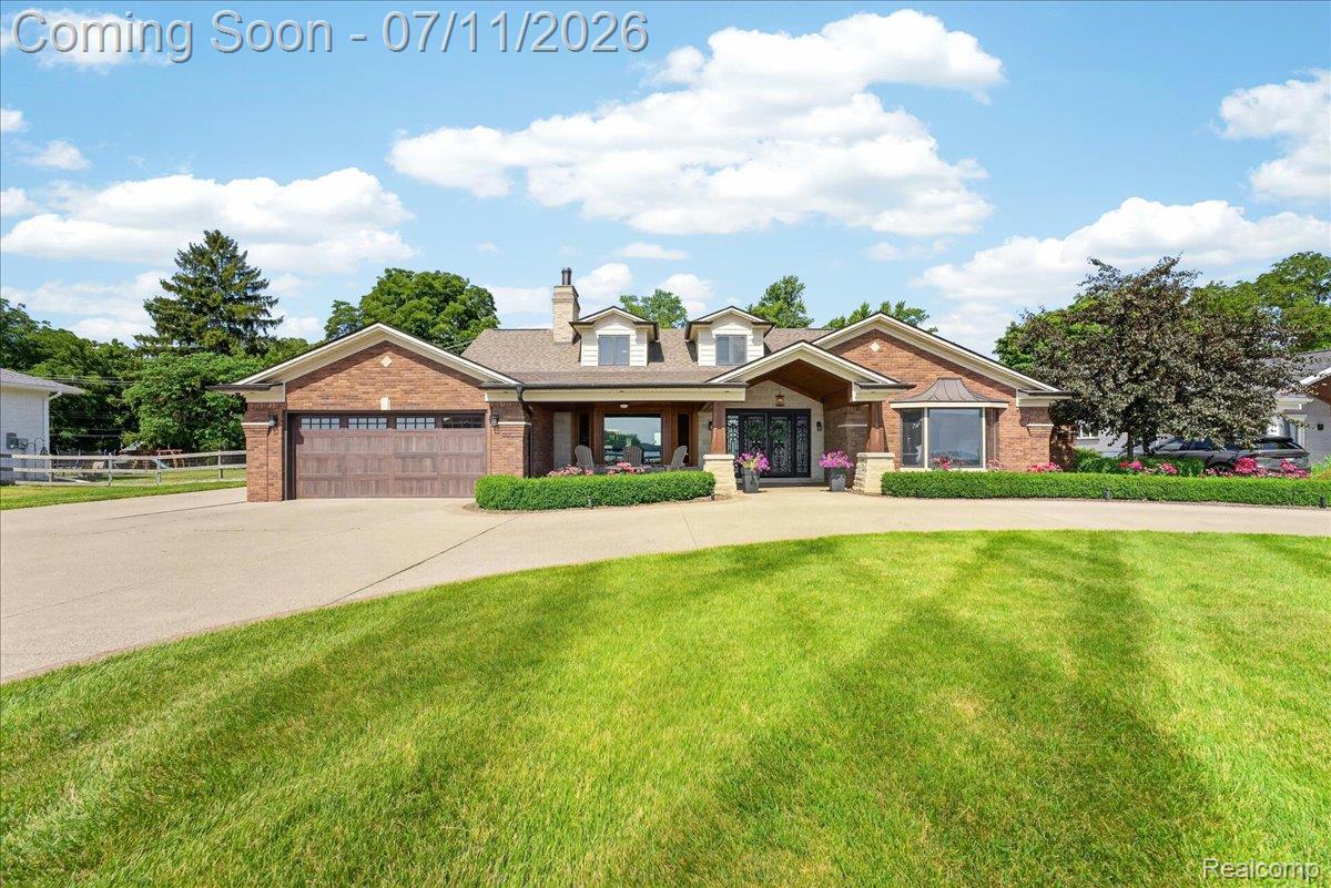 23750 East River Road Grosse Ile, MI 48138 - Photo 1 of 54 Brick exterior residence with a prominent gabled entry and a stone chimney