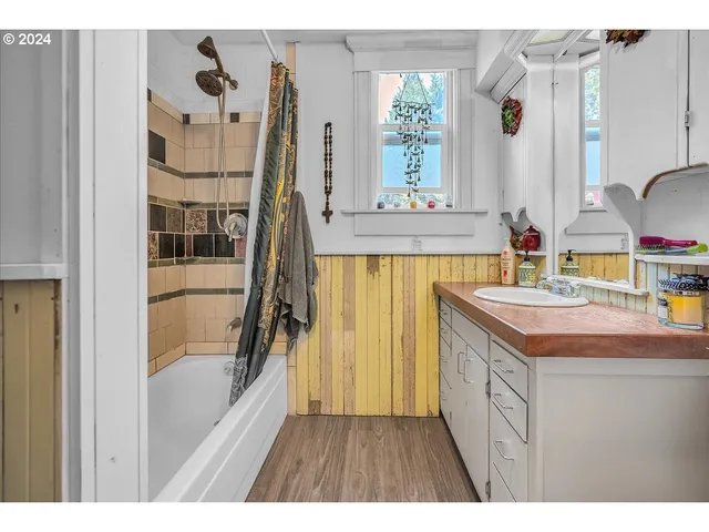 a bedroom with a bed and a large mirror on the dresser