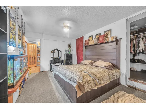 a bedroom with a bed and a bookshelf
