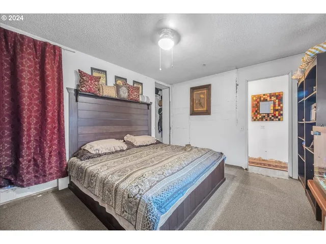 a living room with lots of books and a large window